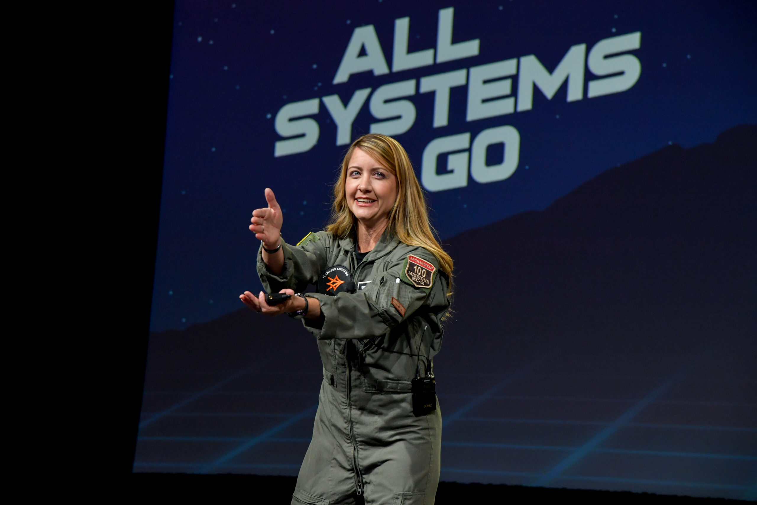 Female Fighter Pilot speaking on stage