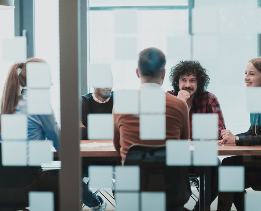 View Through A Window Of People In Business Meeting Smiling