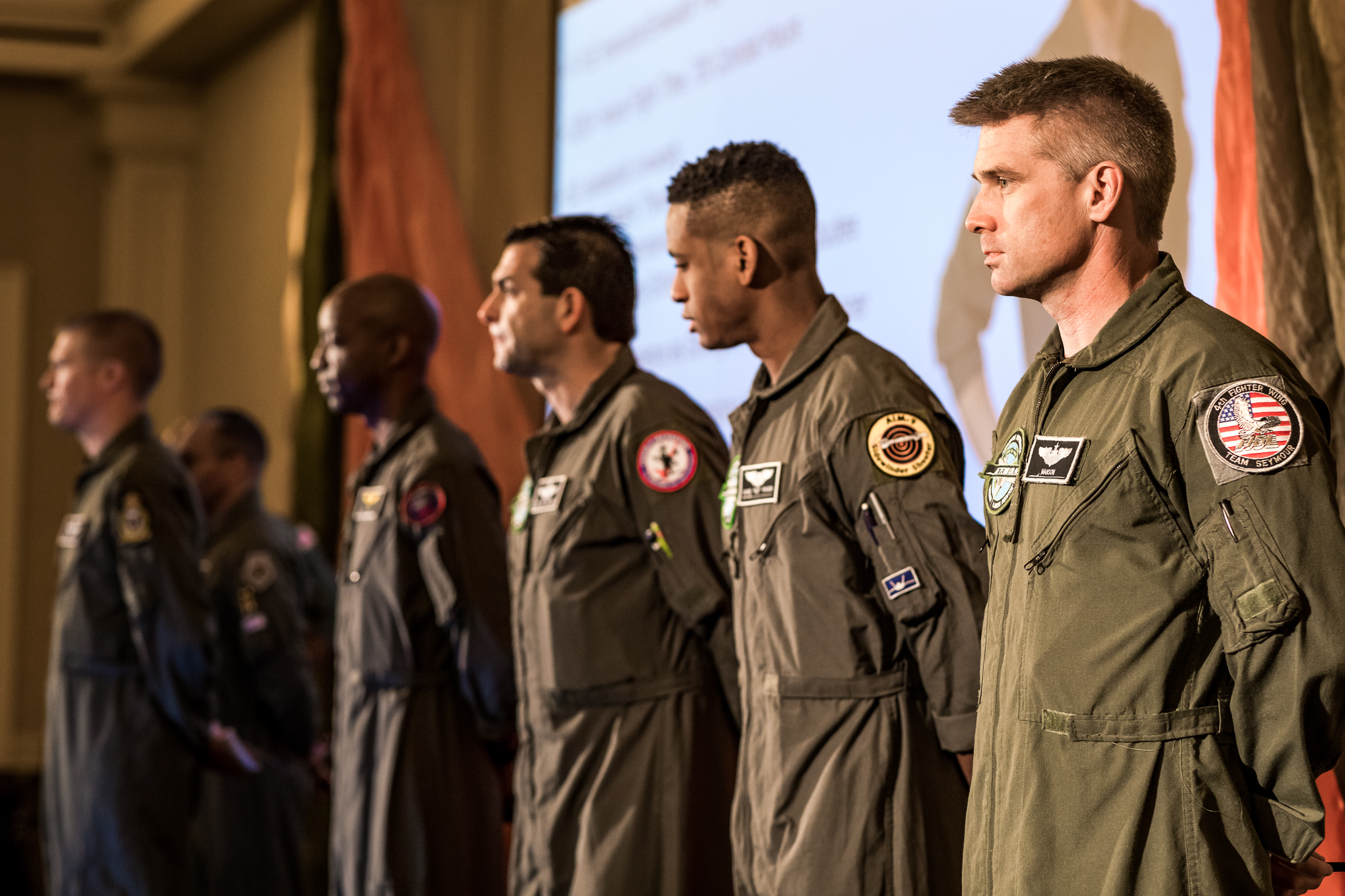 Group of Afterburner’s fighter pilot speakers standing in formation, representing elite leadership under pressure.