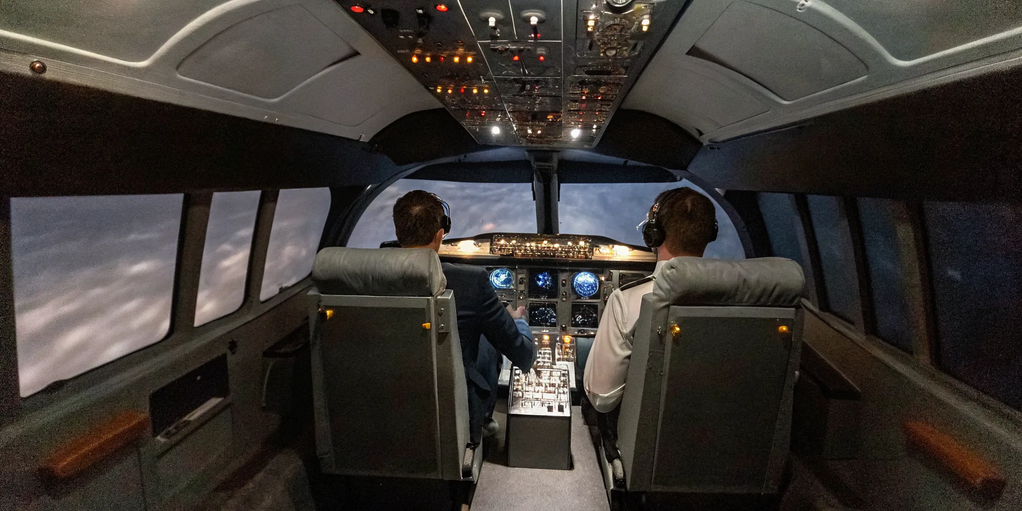 Team building leadership and decision-making skills in a flight simulator cockpit.