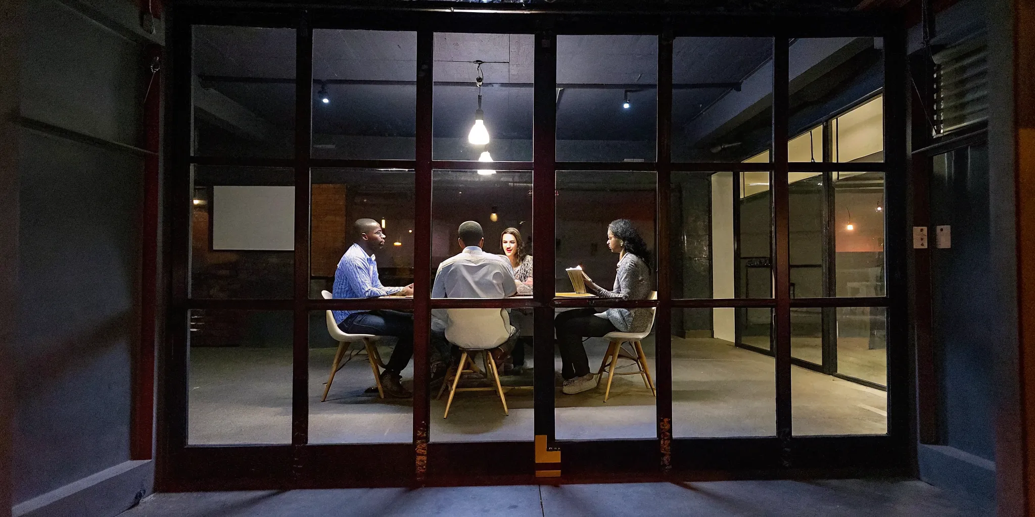 Enterprise leaders engaged in a coaching conversation in a modern office