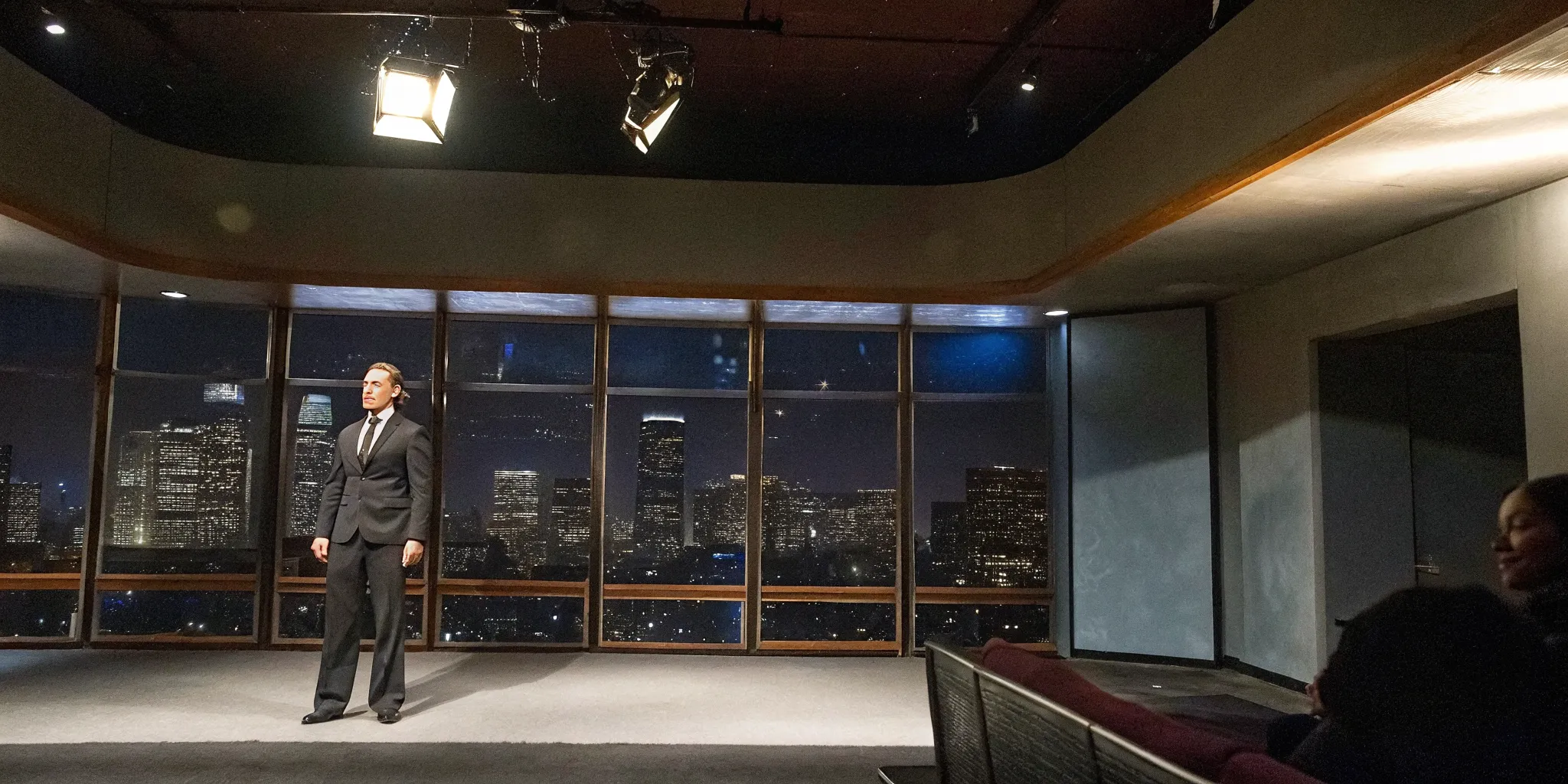 Leadership keynote speaker on stage in Los Angeles addressing a corporate audience with city skyline backdrop