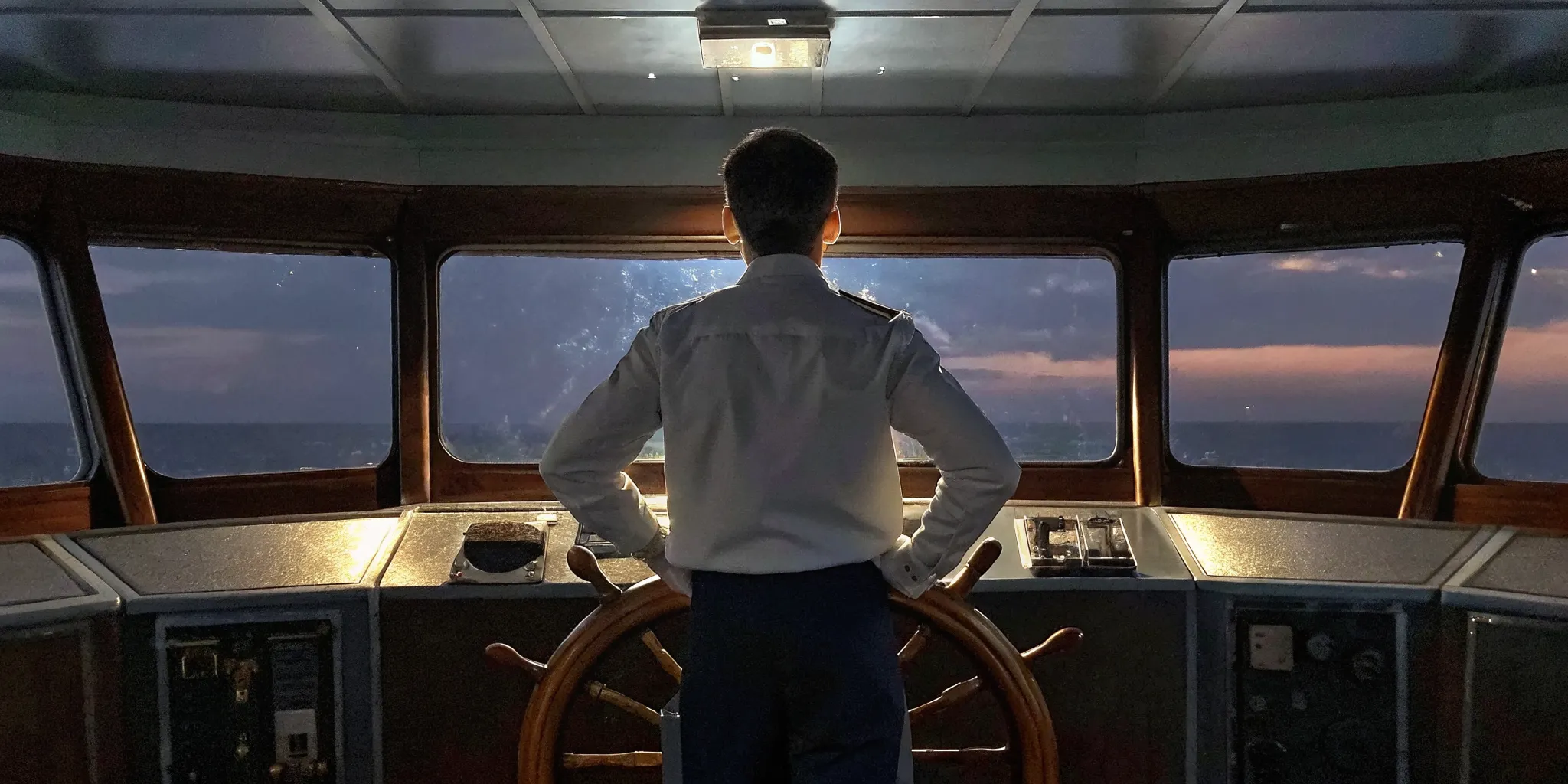 Business leader looking toward the horizon at sunrise, symbolizing succession planning and future leadership