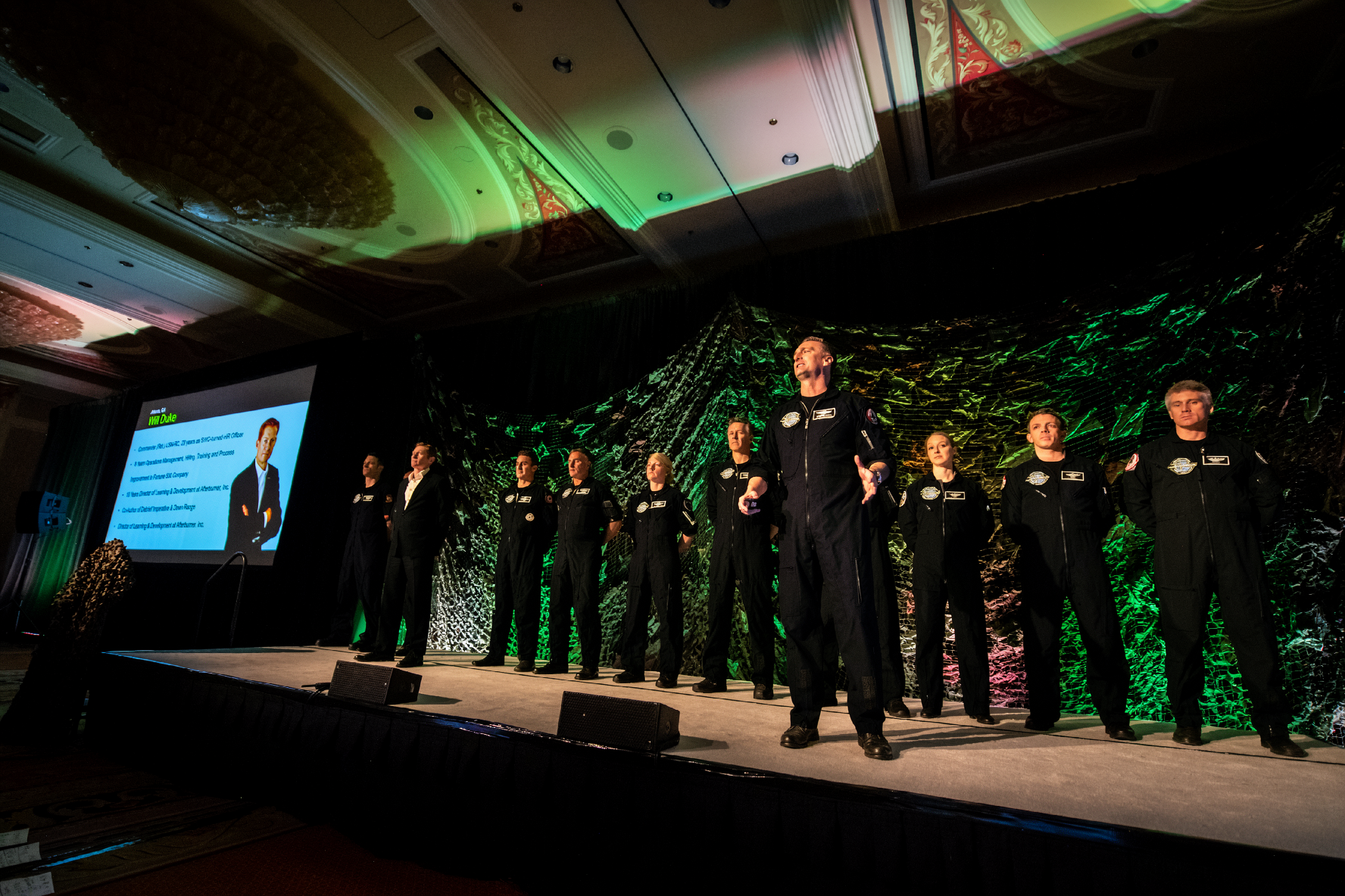 Afterburner pilots and a client team on stage at a corporate event
