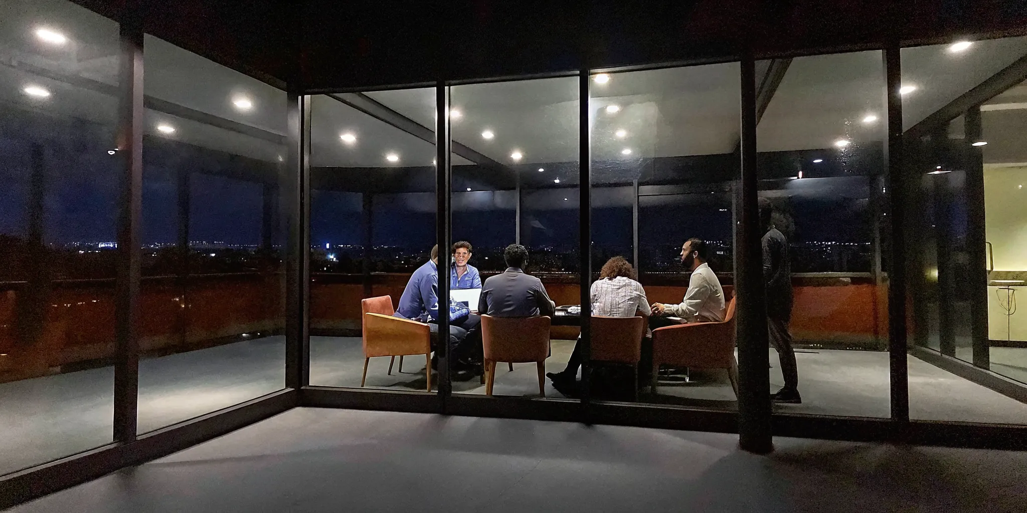 High-growth corporate team collaborating in a modern meeting room with focused energy and leadership dynamics